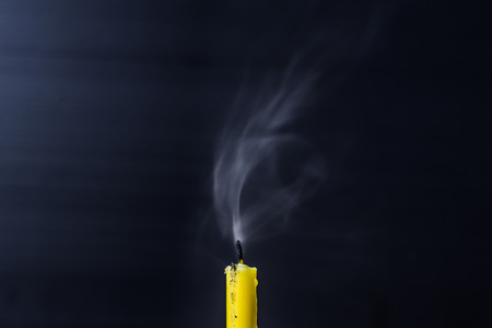 The extinguished candle with smoke, close upの写真素材