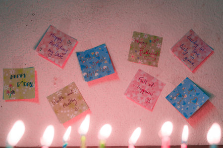 Birthday greeting note and candle light,