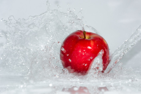 Make the apple looks fresher by splash the water to them and capture the moment.の写真素材