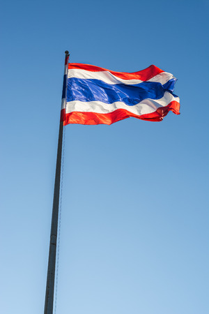 Image of waving Thai flag of Thailand with blue sky background.の写真素材