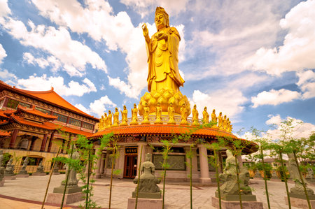 Khlong Sam Wa, Bangkok, Thailand - October 27, 2019 : Fo Guang Shan Thaihua Temple - .A large, golden Guanyin statue on the side of the templeのeditorial素材