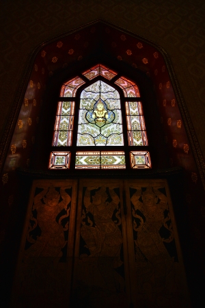 The figure of a deva clasping hands on Stained glass window at Wat Benchamabophit, Bangkok Thailandのeditorial素材