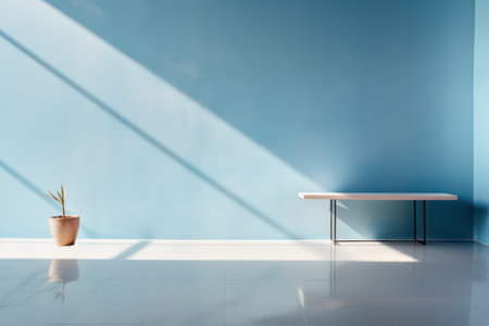 Minimalist room with blue wall, sunlight, plant, and tableの素材