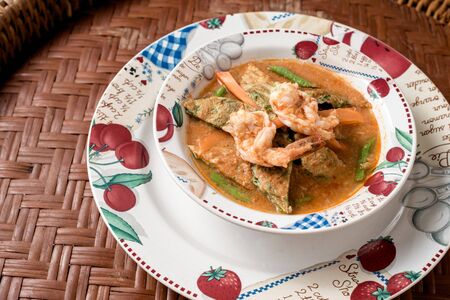 Thai popular food. Sour curry in the pot on basketry.の写真素材