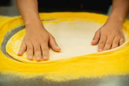 Pizza dough on the table in the restaurant.の写真素材