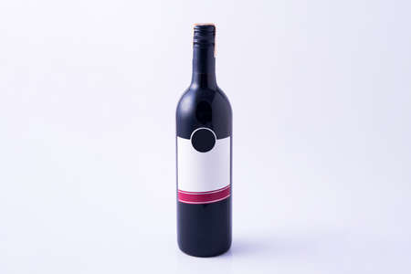 Red wine bottle without label on white background.の写真素材