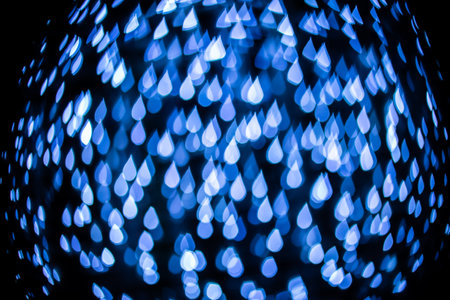 Abstract blue water drop bokeh on black background.の写真素材