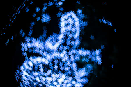 Abstract blue star bokeh on black background.の写真素材