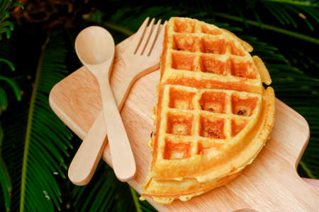 Delicious waffles on the wooden plate at garden.の写真素材