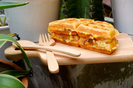 Delicious waffles on the wooden plate at garden.の写真素材