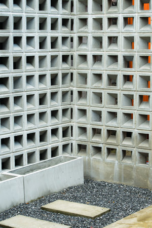Brick cement wall and cement plant pot on the rock.
