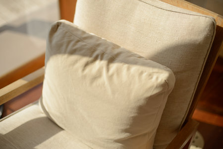 Cozy style. Beige cushions decorate the house on the sofa at afternoon.の写真素材
