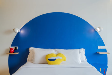 Stylish Bedroom Interior with Art Deco Accents and a Playful Lips Pillow.