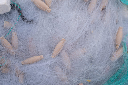 Close-up photograph of a traditional fishing net with foam floats. Professional photography with...