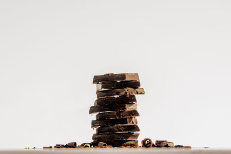 Stacked chocolate chunks on the white background.の写真素材