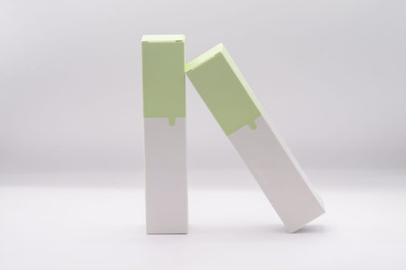 Two white and green product boxes on the white background