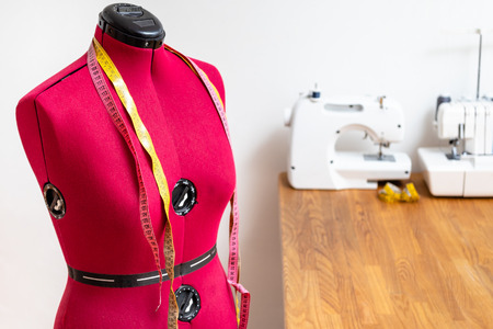 tailor's dummy with two measuring tapes in dressmaker workshopの写真素材