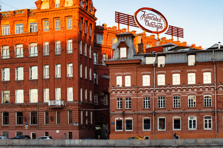 MOSCOW, RUSSIA - SEPTEMBER 27, 2018: view of Red October business center in former factory building Krasniy Oktyabr on Bersenevskaya Embankment in Moscow city from Moskva river in sunny autumn eveningのeditorial素材