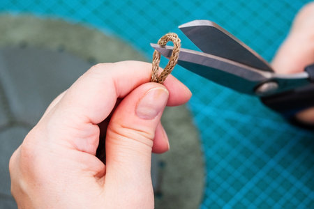 workshop of making the leather bag for jewelry - craftsman cuts drawstring for pouch by scissors...