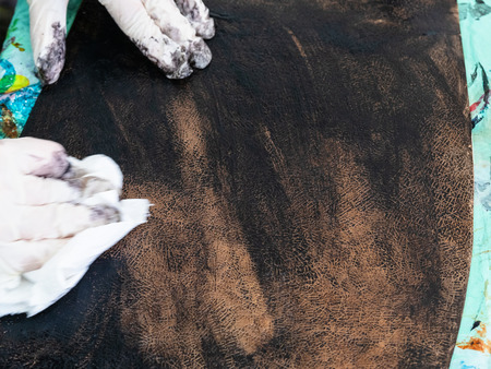 workshop of making the carved leather bag - craftsman colors the carved leather for handbagの写真素材
