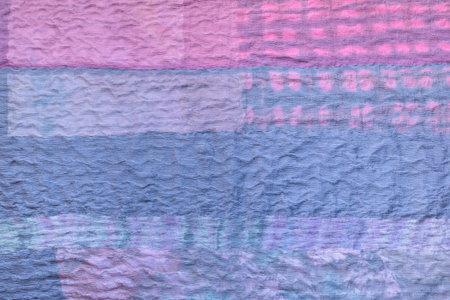 textile background from silk stitched scarf - blue back side of patchwork cloth