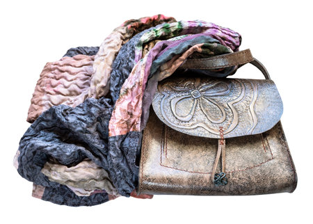 handmade carved leather handbag wrapped of the patchwork scarf cut out on white backgroundの写真素材