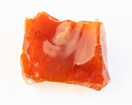 macro photography of natural mineral from geological collection - rough Fire opal stone on white backgroundの写真素材