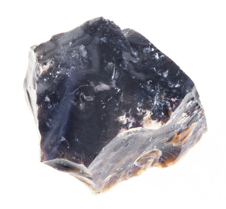 macro photography of natural mineral from geological collection - raw black flint stone on white...