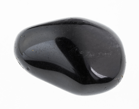 macro photography of natural mineral from geological collection - tumbled obsidian (volcanic glass) gemstone on white backgroundの写真素材
