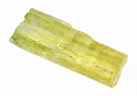 macro photography of natural mineral from geological collection - rough heliodor (yellow beryl) crystal on white backgroundの写真素材
