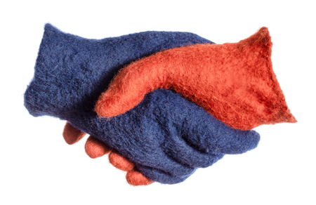 handshake of blue and orange gloves isolated on white backgroundの写真素材
