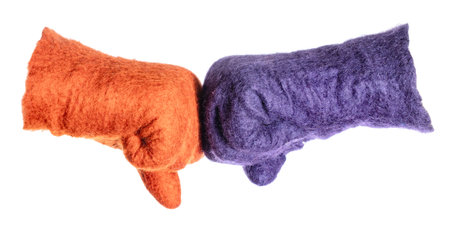 fist bump of orange and purple gloves isolated on white background