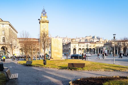 BERGAMO, ITALY - FEBRUARY 19, 2019: people on square Piazza Giacomo Matteotti and Tower Torre dei Caduti on street Viale Roma. Bergamo is capital of the Province of Bergamo in Lombardy region of Italyのeditorial素材