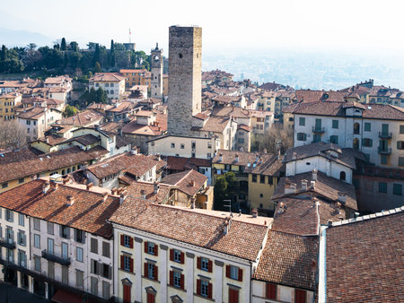 Travel to Italy - above view of the east of Bergamo city with Torre del Gombito, bell tower of Chiesa di San Pancrazio and Fortress Rocca di Bergamo from Campanone tower in Citta Alta (Upper Town)の写真素材