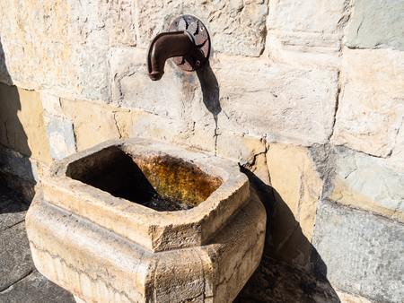 Travel to Italy - street fountain Fontana di Porta Dipinta in medieval wall of Citta Alta (Upper Town) of Bergamo city, Lombardyの写真素材