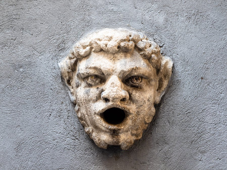 Travel to Italy - medieval mascaron in ancient city wall on street via Alla Rocca in Citta Alta (Upper Town) of Bergamo city, Lombardyの写真素材