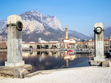 LECCO, ITALY - FEBRUARY 20, 2019: pier on waterfront Lungolario Isonzo of Lario Como Lake and Lecco city with mount Monte San Martino. Lecco is city in Lombardy, the capital of the province of Leccoのeditorial素材