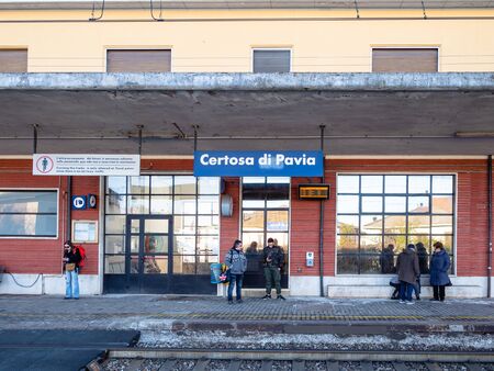 CERTOSA DI PAVIA, ITALY - FEBRUARY 22, 2019:: passengers on platform of railway station in town Certosa di Pavia. Certosa di Pavia is a town in the province of Pavia, Lombardyのeditorial素材