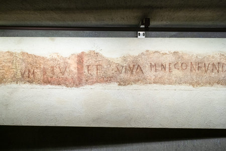 MILAN, ITALY - FEBRUARY 24, 2019: old wall inscription in area of ruined ancient baptistery and...