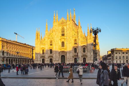 MILAN, ITALY - FEBRUARY 24, 2019: people on square Piazza del Duomo in front of Milan Cathedral (Duomo di Milano) in Milan city at sunset. This Basilica is the largest church in Italyのeditorial素材