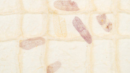 panoramic background from handmade organic paper with purple leaves close up