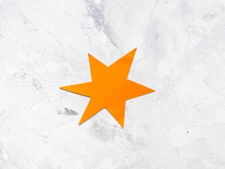 one yellow star cut from paper on gray concrete boardの写真素材