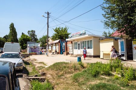 AKHTYRSKY, RUSSIA - JULY 3, 2019: people and cars parking near market on Krasnaya street in Akhtyrskiy urban-type settlement in Abinsky District in Kuban region of Krasnodar Krai of Russiaのeditorial素材