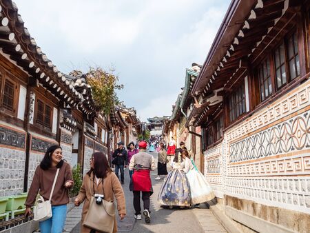 SEOUL, SOUTH KOREA - OCTOBER 31, 2019: tourists walk in Bukchon Hanok Village in Seoul city on autumn day. Buchkhon is one of the old districts of Seoul, which has survived to this day.のeditorial素材