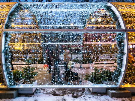 MOSCOW, RUSSIA - JANUARY 2, 2020: people walk under garlands on decorated Tverskoy Boulevard in...