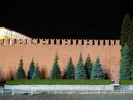 blue spruces near red wall of Kremin ar Red Square of Moscow city at nightの写真素材