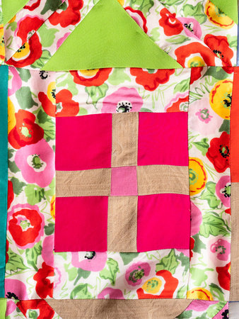 textile background - ornament of hand-stitched colorful patchwork cloth