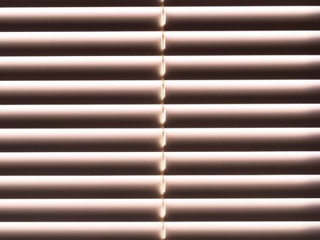 abstract background - horizontal blinds backlighted by sunlight in home windowの写真素材