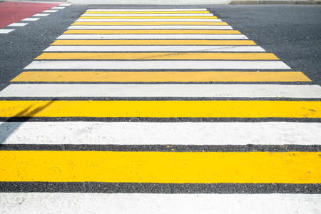 surface of urban road with yellow and white zebra pedestrian crossing on Nikitskiye Vorota square in Moscow cityの写真素材