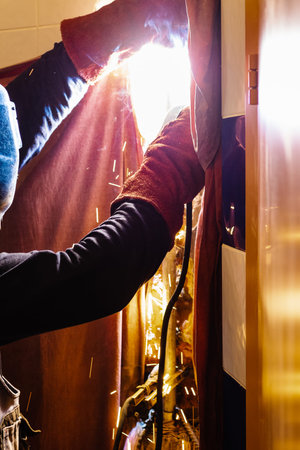 repairing of plumbing riser of heated towel rail at home - welder welds new pipe into plumbing pipe...